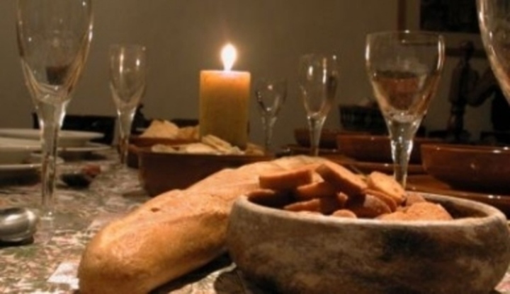 Prostřený stůl s jídlem,skleničkami a svíčkou 